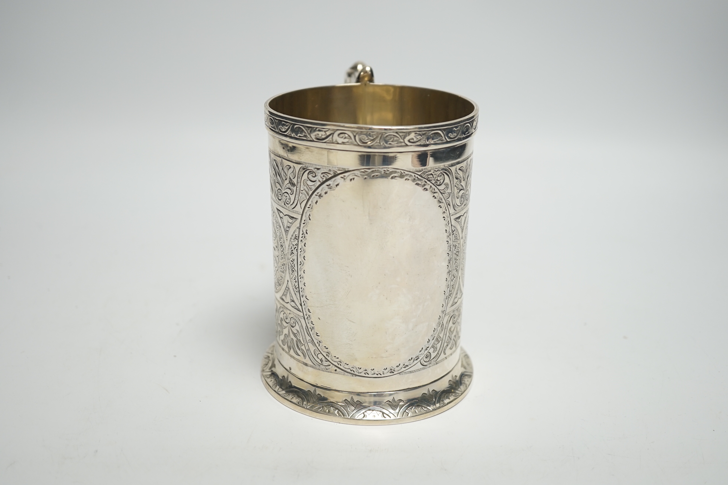 A Victorian engraved silver mug, with ornate handle, George Unite, Birmingham, 1869, height 12.4cm, 12.4oz.